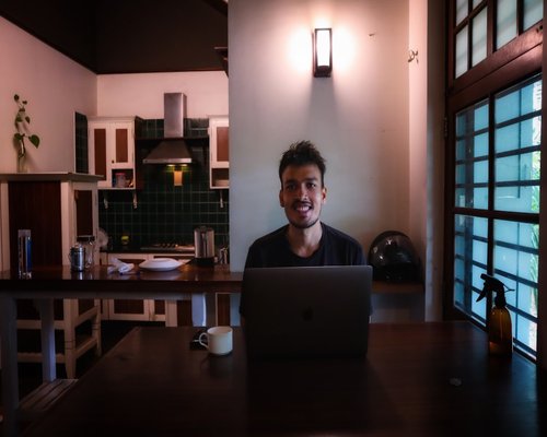 Man closing a laptop at home in the evening