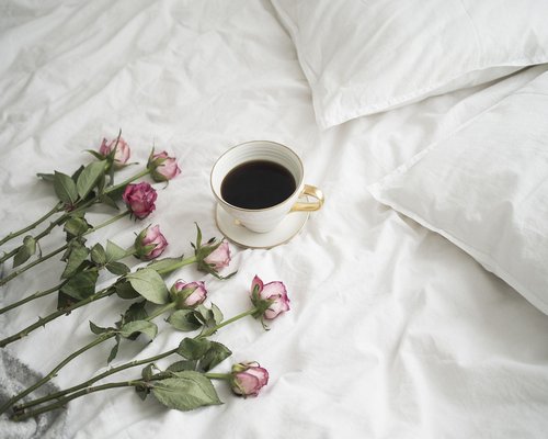 Phone placed aside near a bed in a calm evening scene